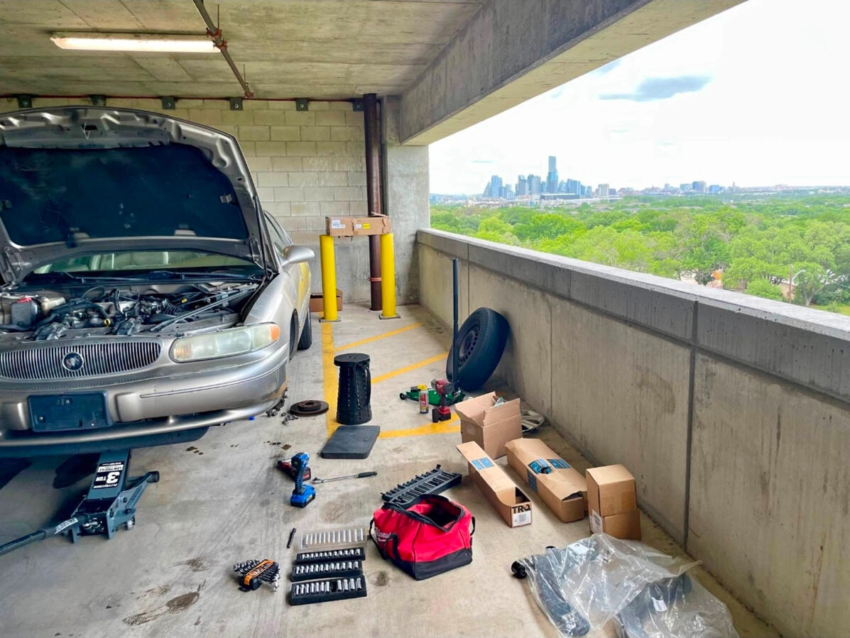 Mobile mechanic performing vehicle repairs in Fort Worth parking garage